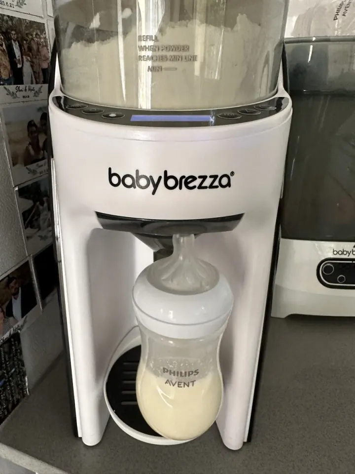Baby Brezza formula maker filling a Philips Avent bottle